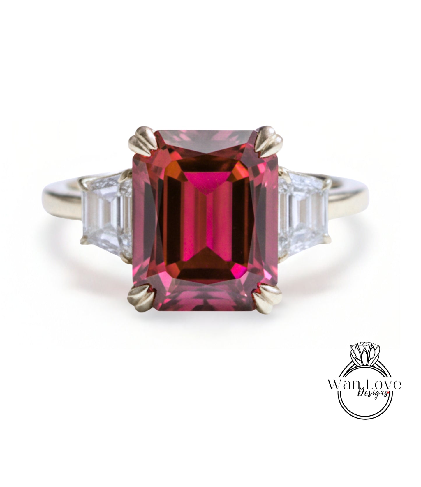 A stunning ring featuring a large, deep red gemstone set in a silver band, with two smaller diamonds on either side.