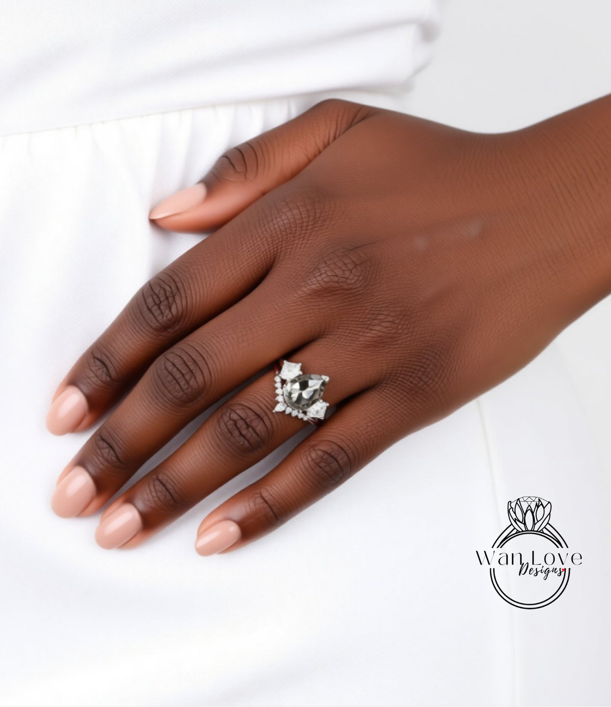 A close-up of a hand wearing a ring with a floral design.