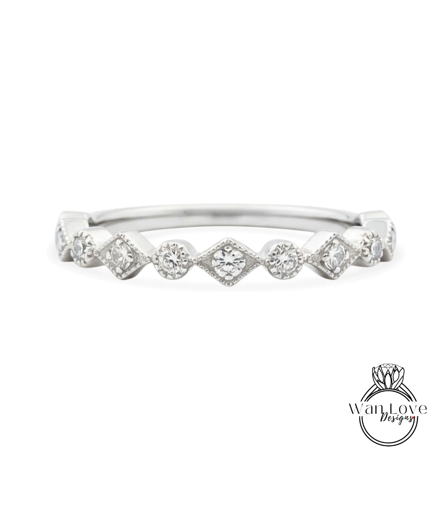 A silver ring with a row of small diamonds set in a diamond-like pattern.