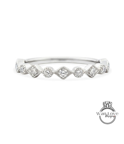 A silver ring with a row of small diamonds set in a diamond-like pattern.