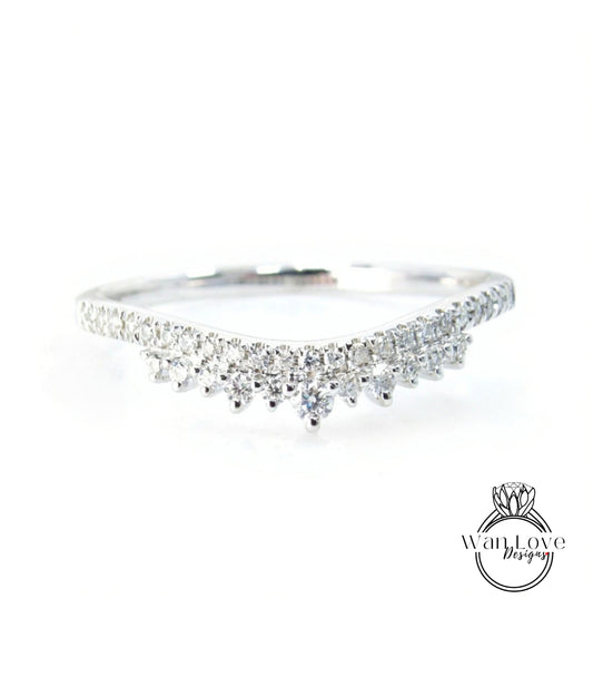 A silver ring with a row of small diamonds set in the band.