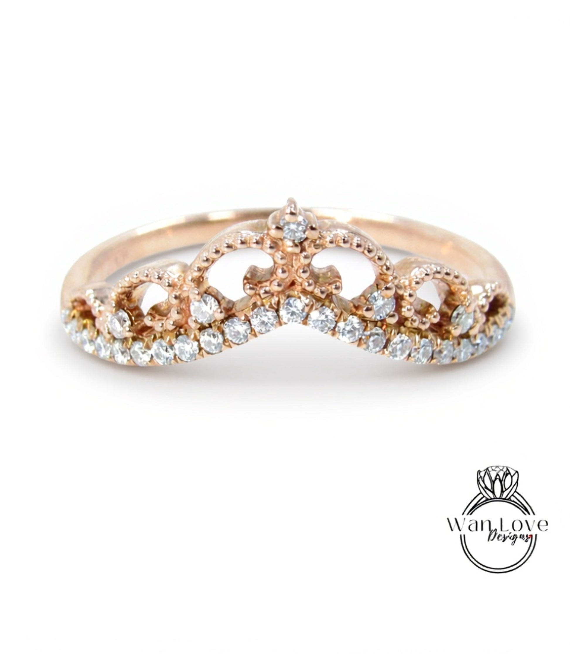 A gold ring with a decorative crown-like design on the top.