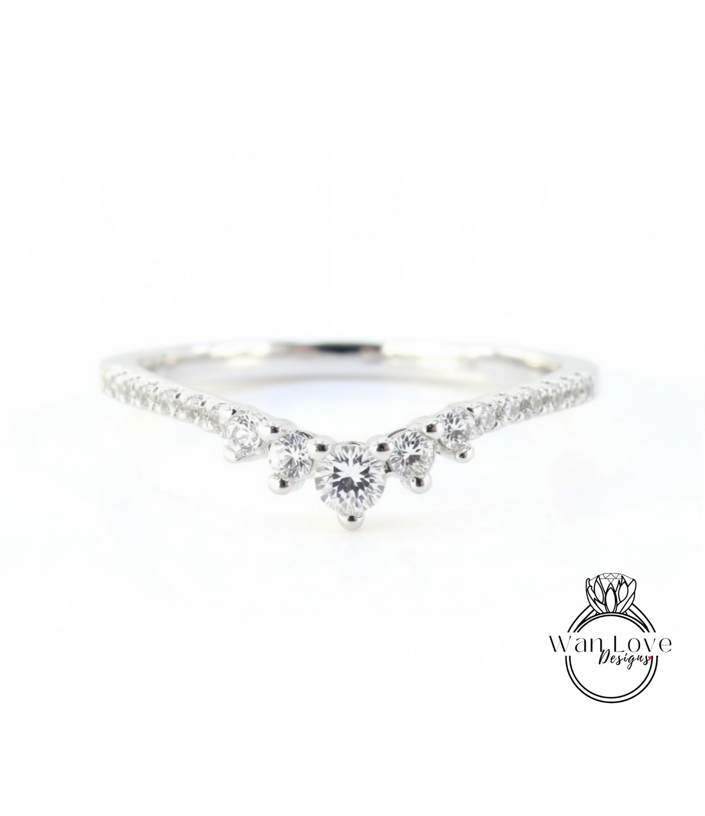 A silver ring with a large central diamond surrounded by smaller diamonds, set in a band.