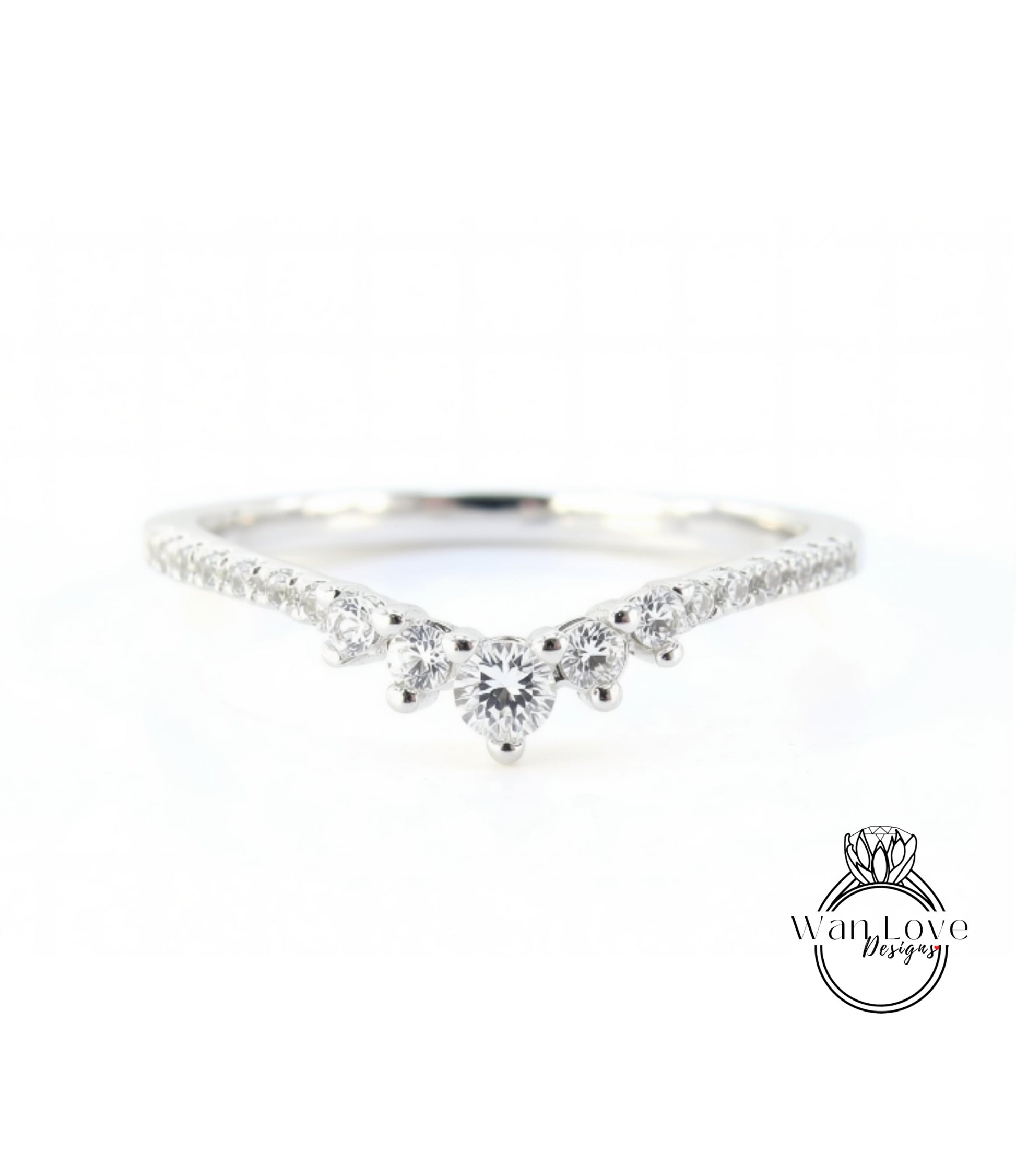 A silver ring with a large central diamond surrounded by smaller diamonds, set in a band.