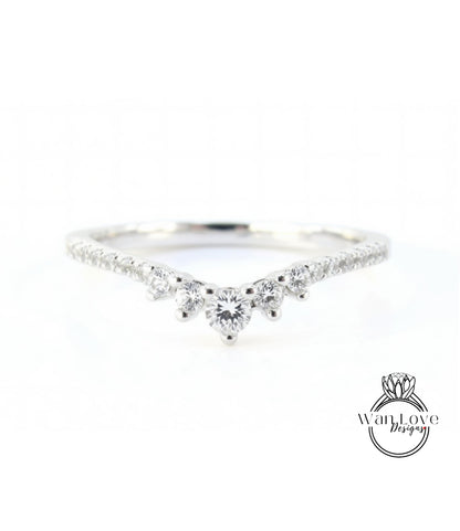 A silver ring with a large central diamond surrounded by smaller diamonds, set in a band.