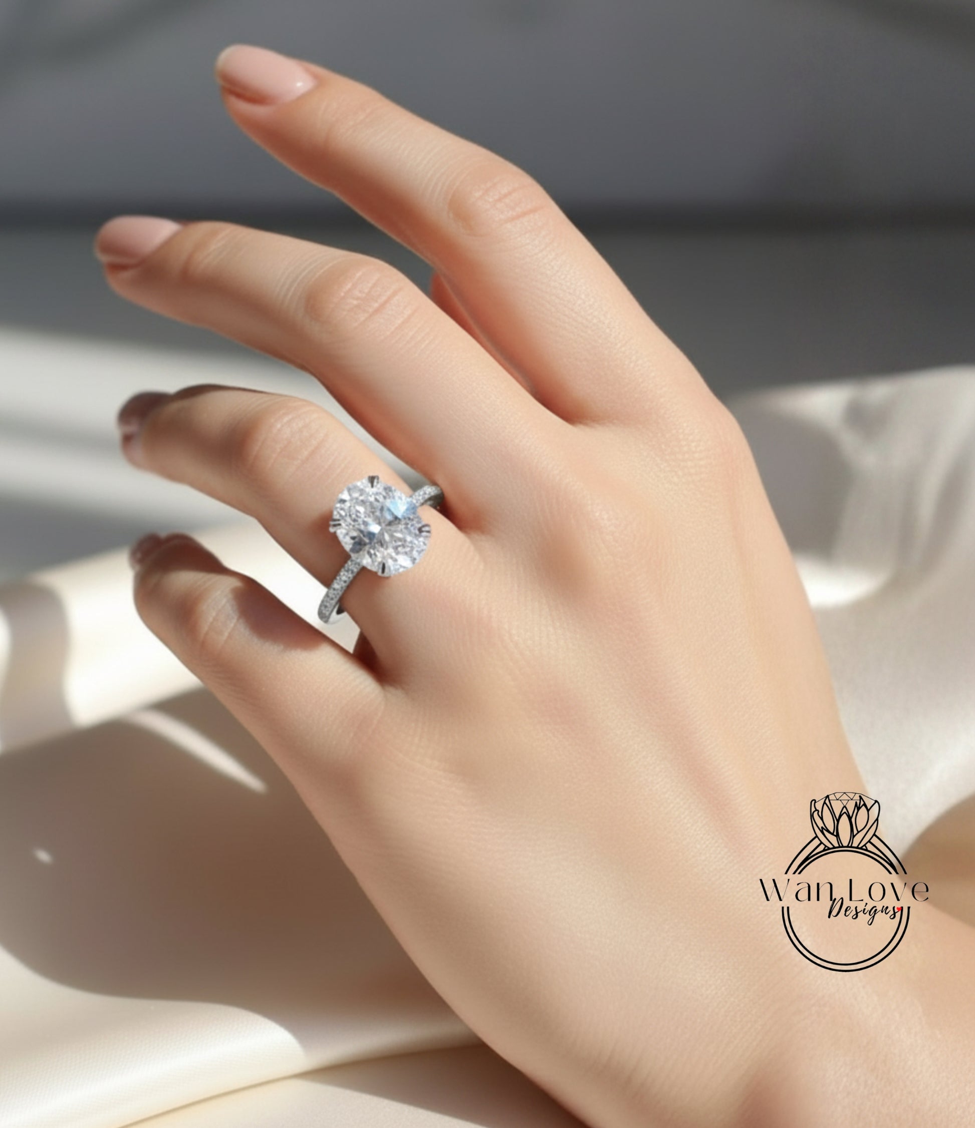 A close-up of a hand wearing a diamond engagement ring, with the ring's diamond visible.