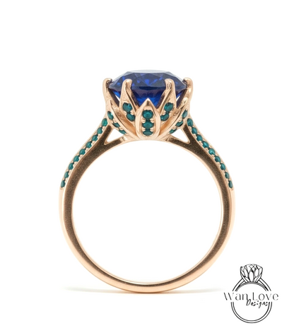 A gold ring with a large blue gemstone at the center, surrounded by small green stones.