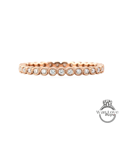 A rose gold ring with a row of small diamonds set in the center.