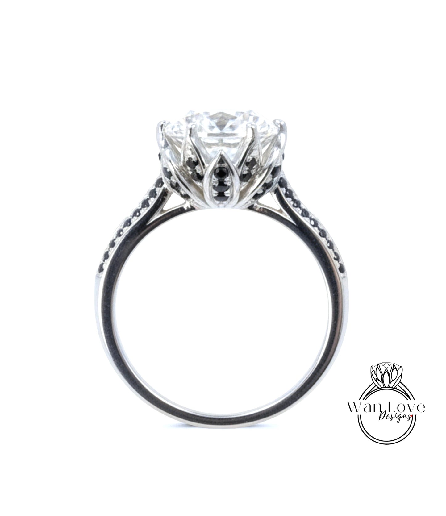 A close-up view of a silver engagement ring with a large central diamond surrounded by smaller diamonds and a floral-inspired design.