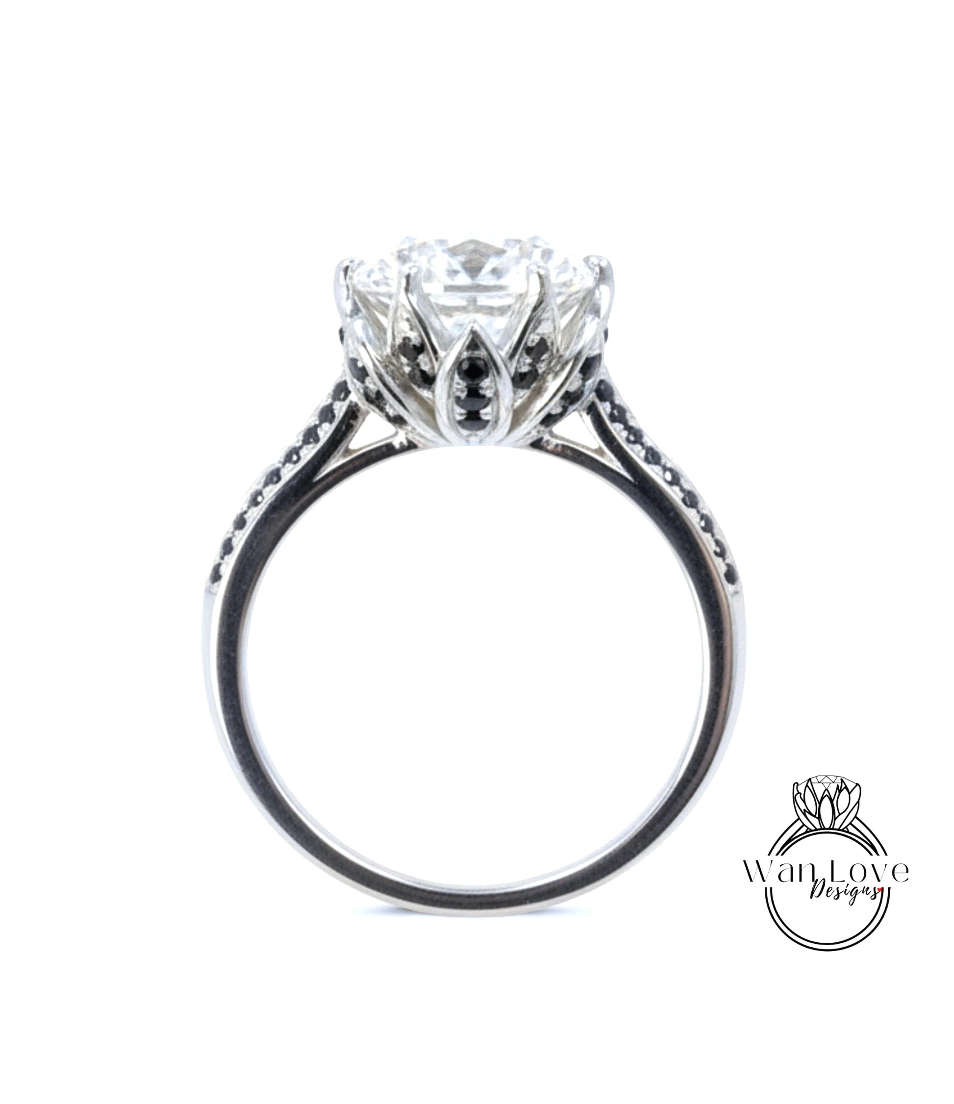 A close-up view of a silver engagement ring with a large central diamond surrounded by smaller diamonds and a floral-inspired design.