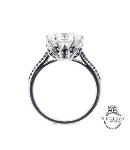 A close-up view of a silver engagement ring with a large central diamond surrounded by smaller diamonds and a floral-inspired design.