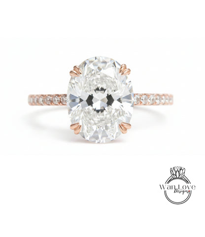 A close-up of a diamond engagement ring with a large oval-shaped diamond set in a rose gold band.