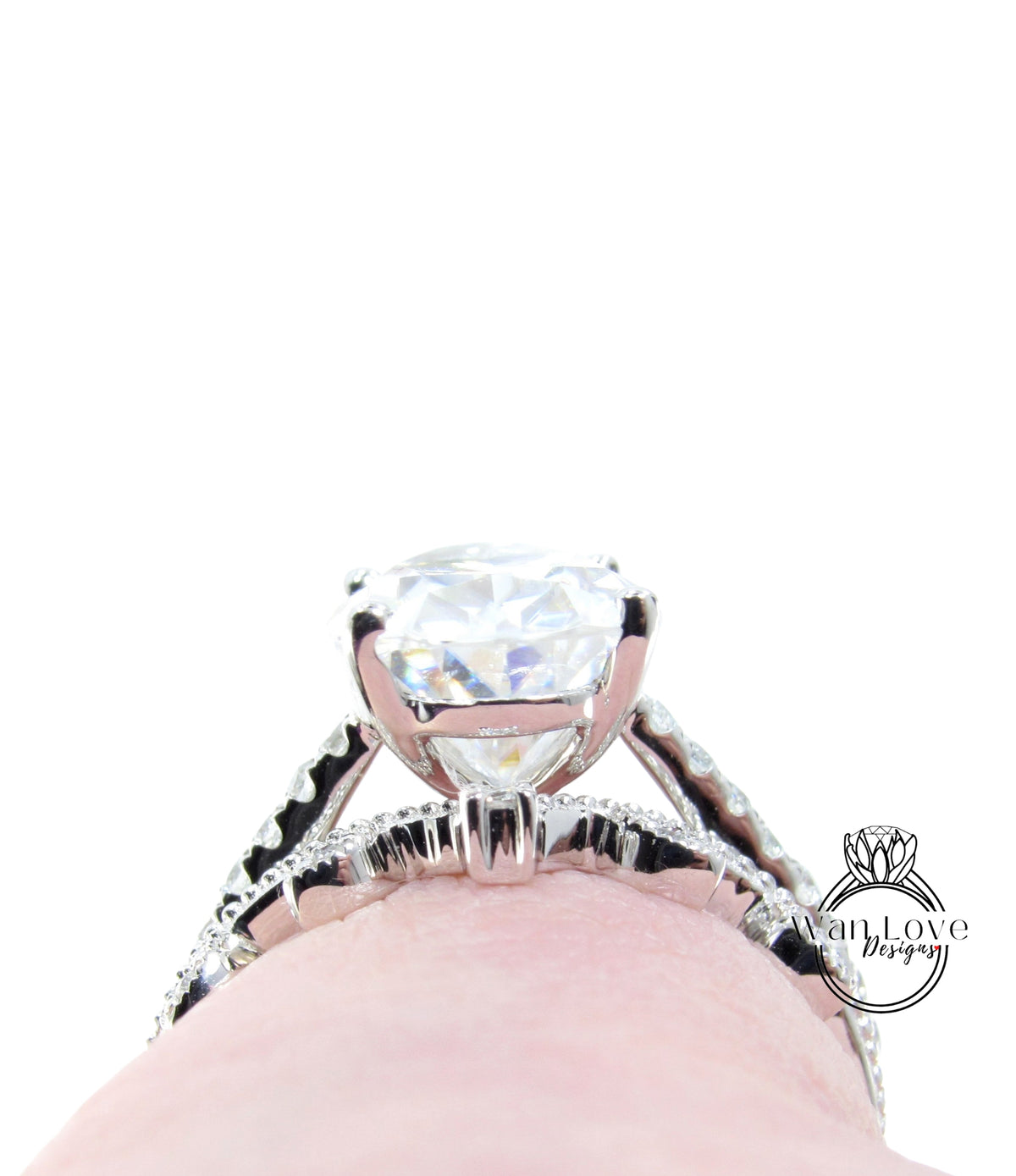 A close-up view of a large, sparkling diamond engagement ring on a person's finger.