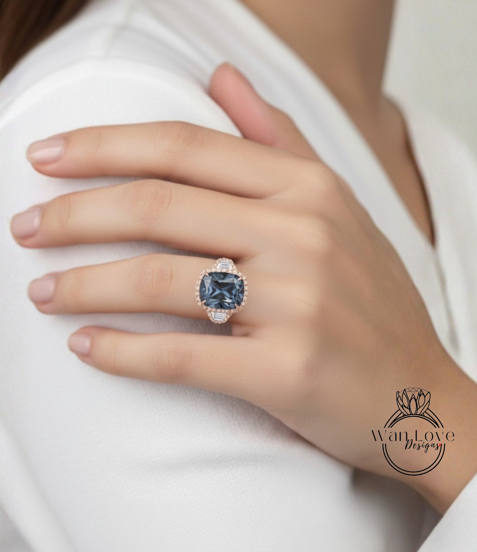 A close-up of a person's hand wearing a large, blue gemstone ring with a gold band.