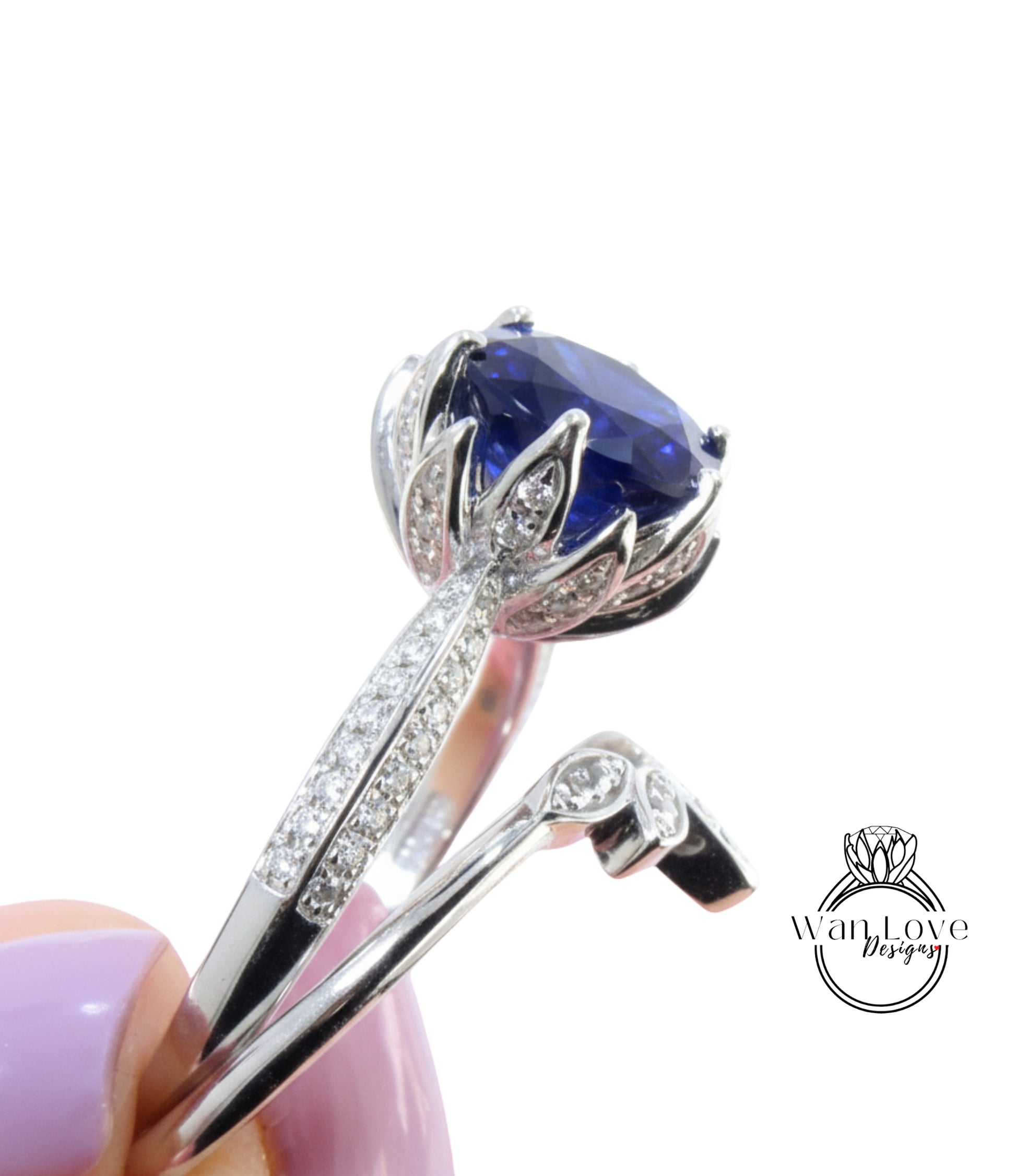 A close-up view of a silver ring with a large blue gemstone, showcasing the intricate design and sparkling diamonds.