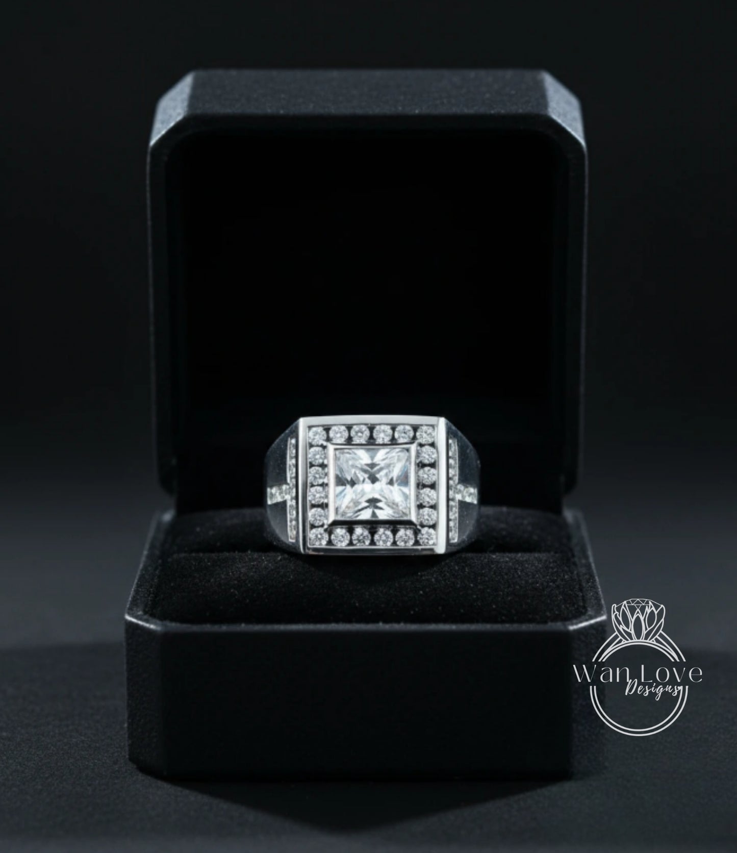 A diamond ring is displayed in a black jewelry box against a dark background.