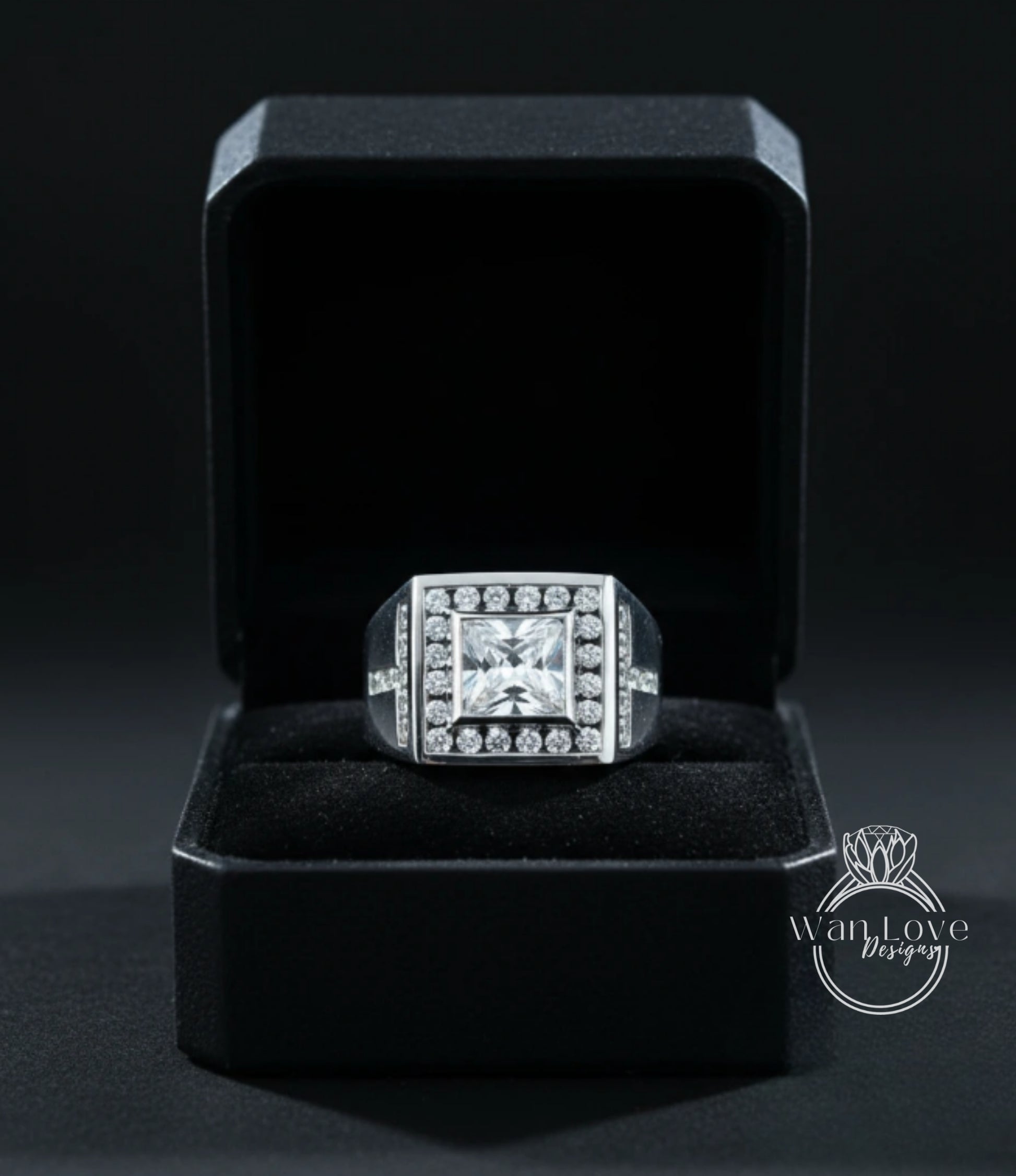 A diamond ring is displayed in a black jewelry box against a dark background.