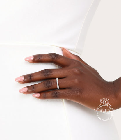 A close-up of a hand wearing a ring on the ring finger.