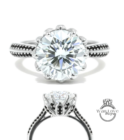 A stunning diamond engagement ring with a large round brilliant cut diamond set in a silver band adorned with black accents.