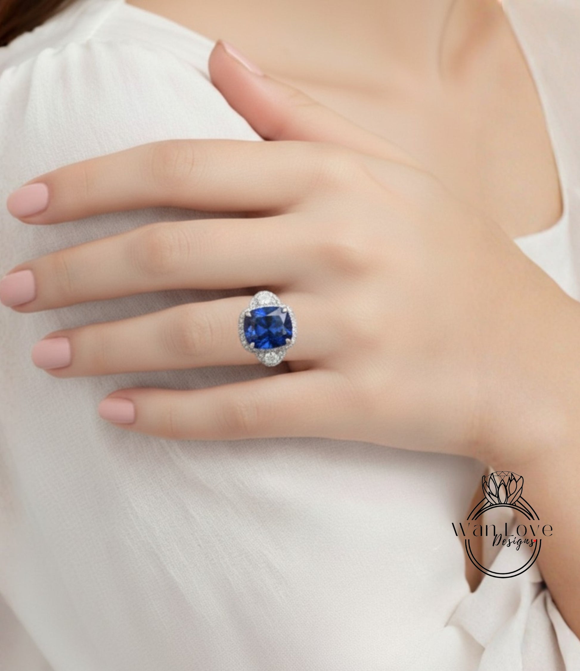 A close-up of a person's hand wearing a large, blue gemstone ring.