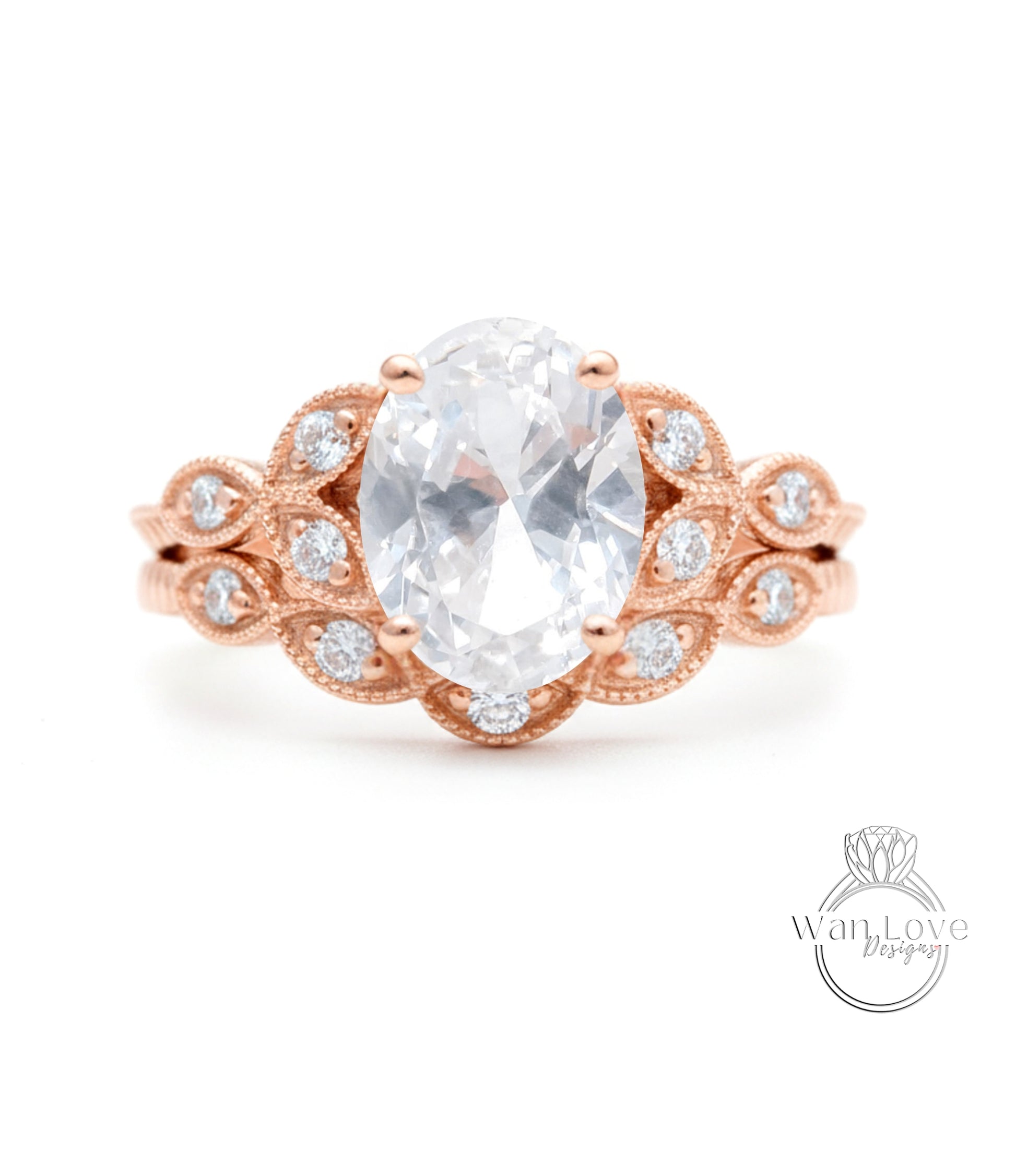 a beautiful engagement ring with a large oval-shaped gemstone surrounded by intricate floral designs and small diamonds.