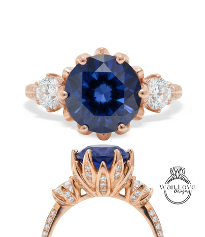 a beautiful blue gemstone ring with a large central blue gemstone surrounded by smaller diamonds. The ring is designed with a delicate floral pattern and has a rose gold band.