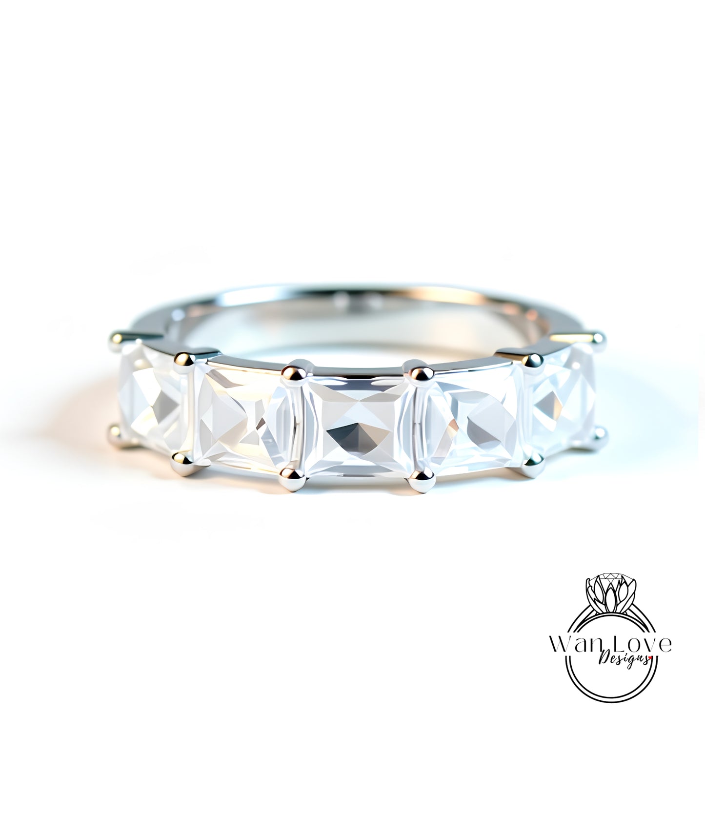 A close-up image of a silver ring with a row of clear gemstones, showcasing the intricate design and craftsmanship of the piece.