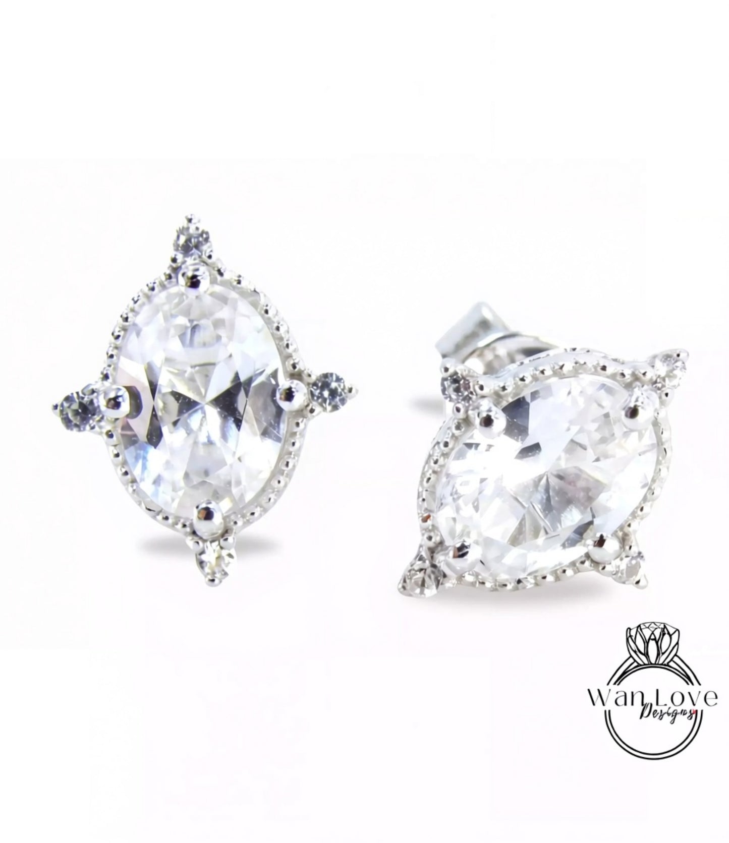 A pair of elegant earrings with large, clear gemstones set in a decorative metal frame.