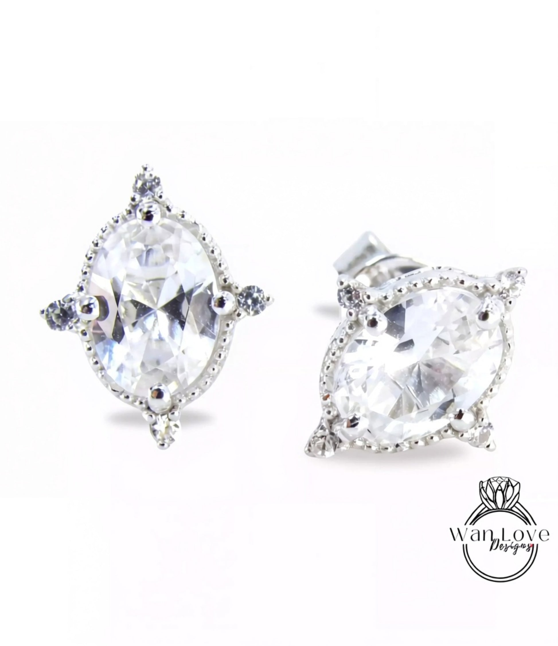 A pair of elegant earrings with large, clear gemstones set in a decorative metal frame.