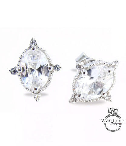 A pair of elegant earrings with large, clear gemstones set in a decorative metal frame.