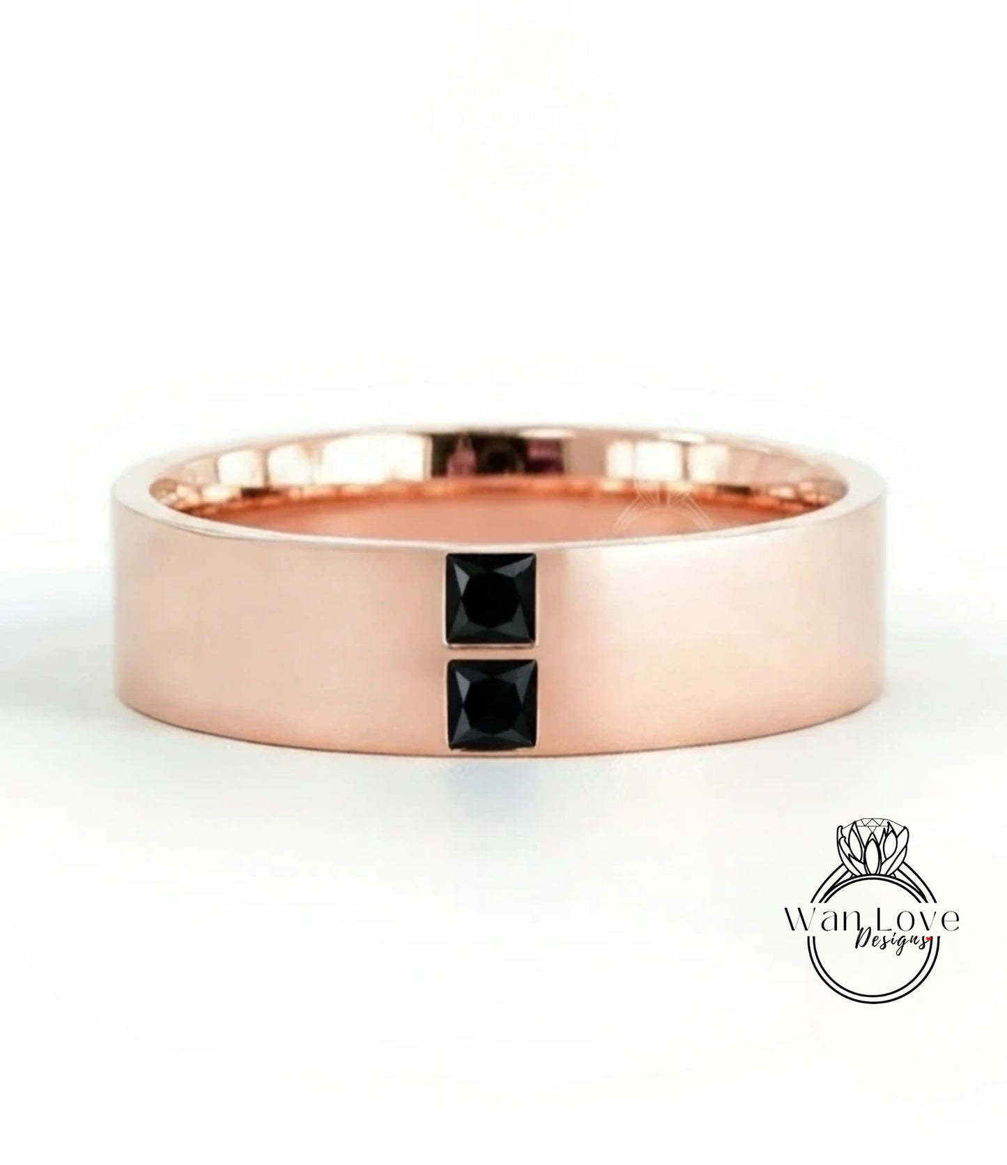 A rose gold ring with a large central gemstone and two smaller gemstones on either side.