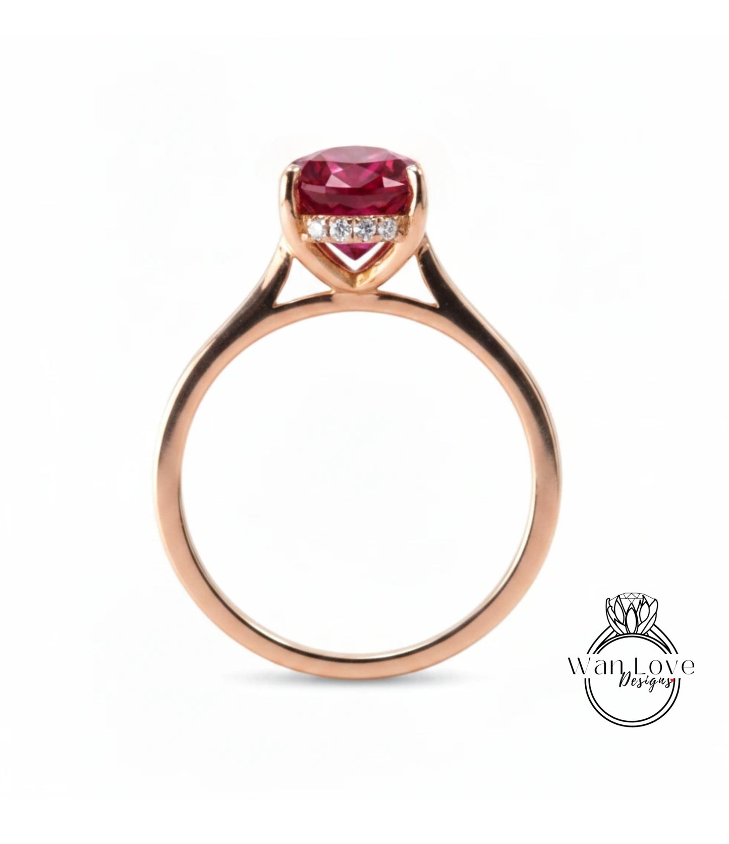 A rose gold engagement ring with a large, deep red gemstone set in the center.