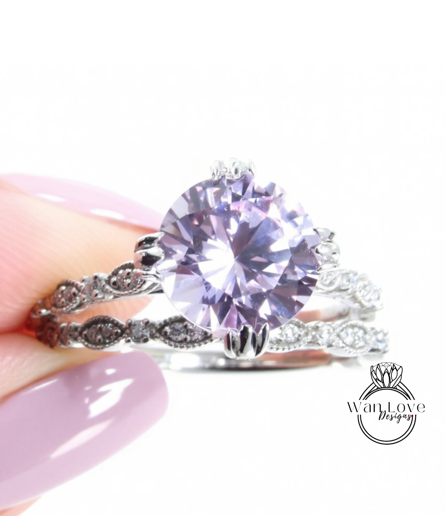 A close-up of a person's hand holding a ring with a large, round purple gemstone.