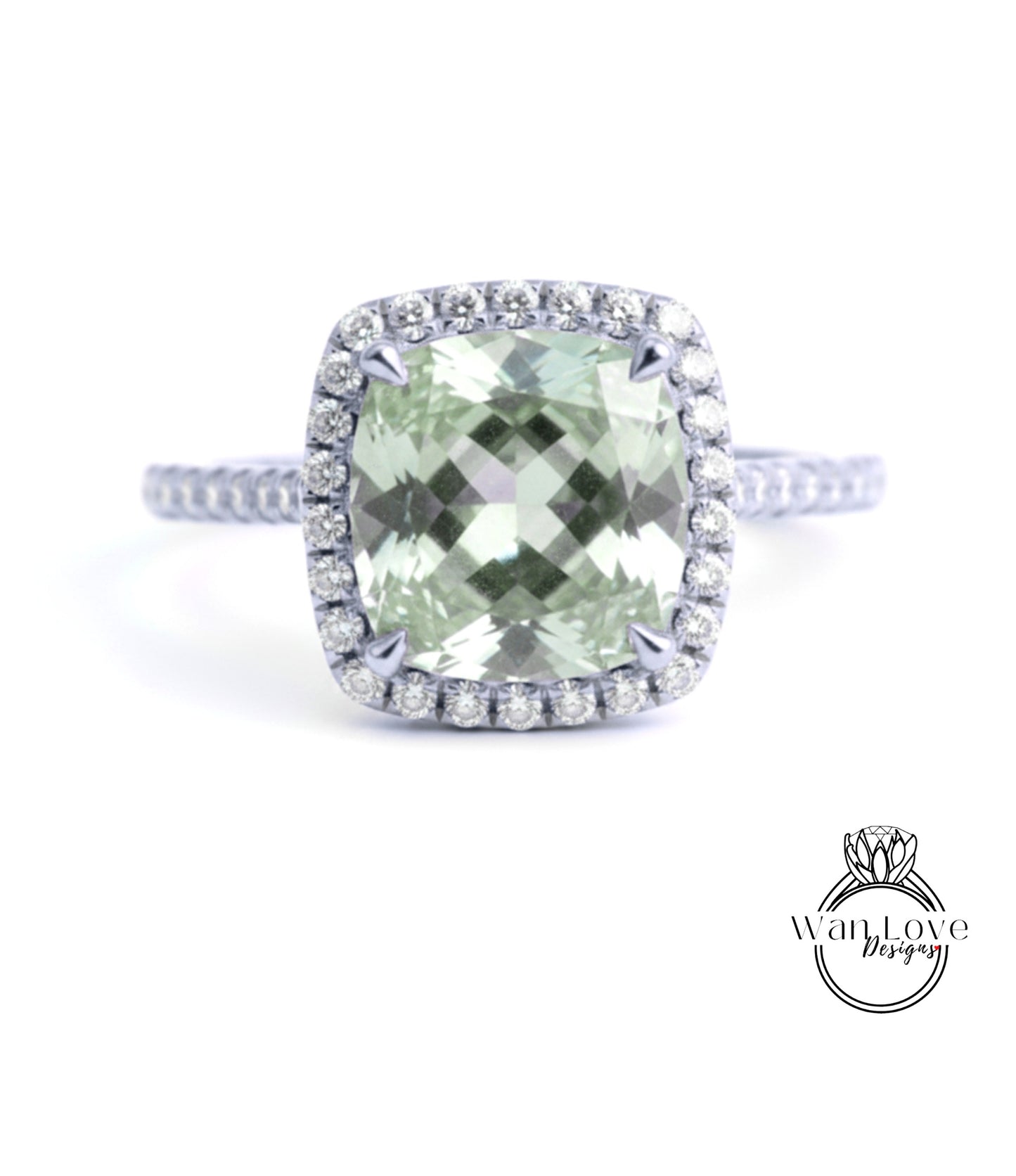 A diamond ring with a large, square-cut green gemstone surrounded by a halo of smaller diamonds set in a silver band.