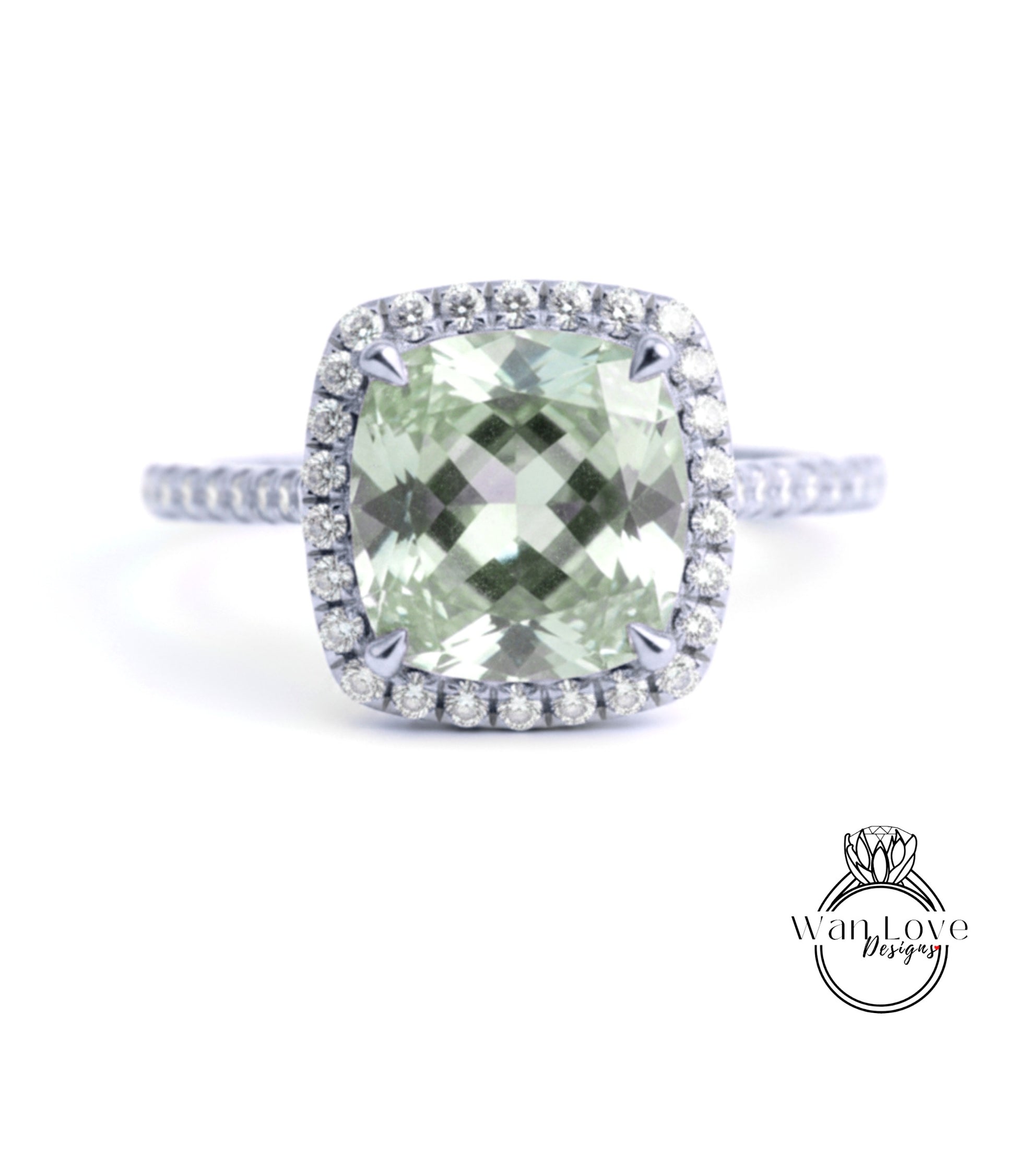 A diamond ring with a large, square-cut green gemstone surrounded by a halo of smaller diamonds set in a silver band.