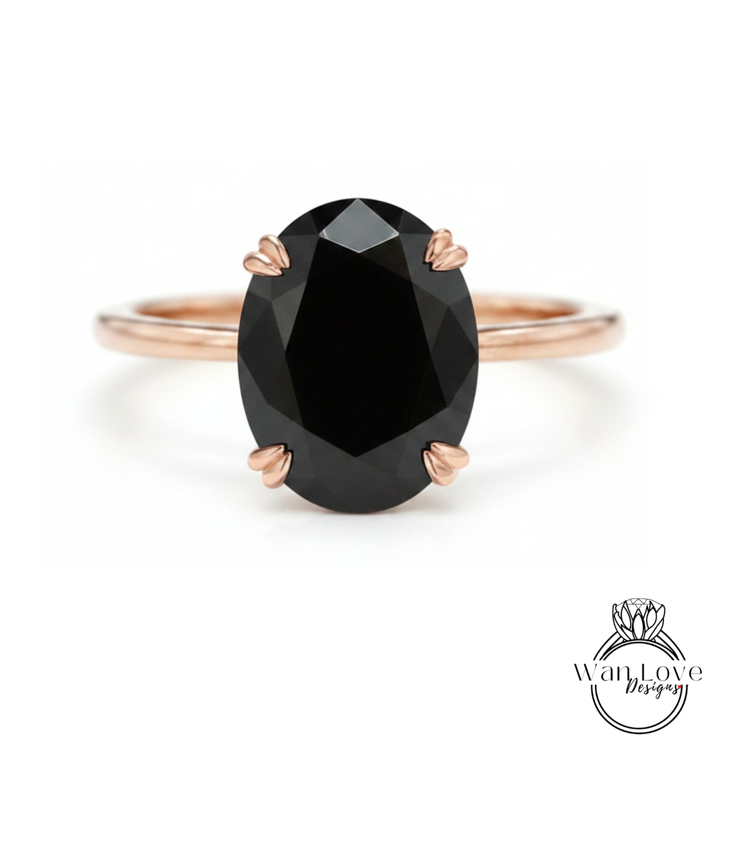 A rose gold ring with a large oval-shaped black gemstone set in the center.