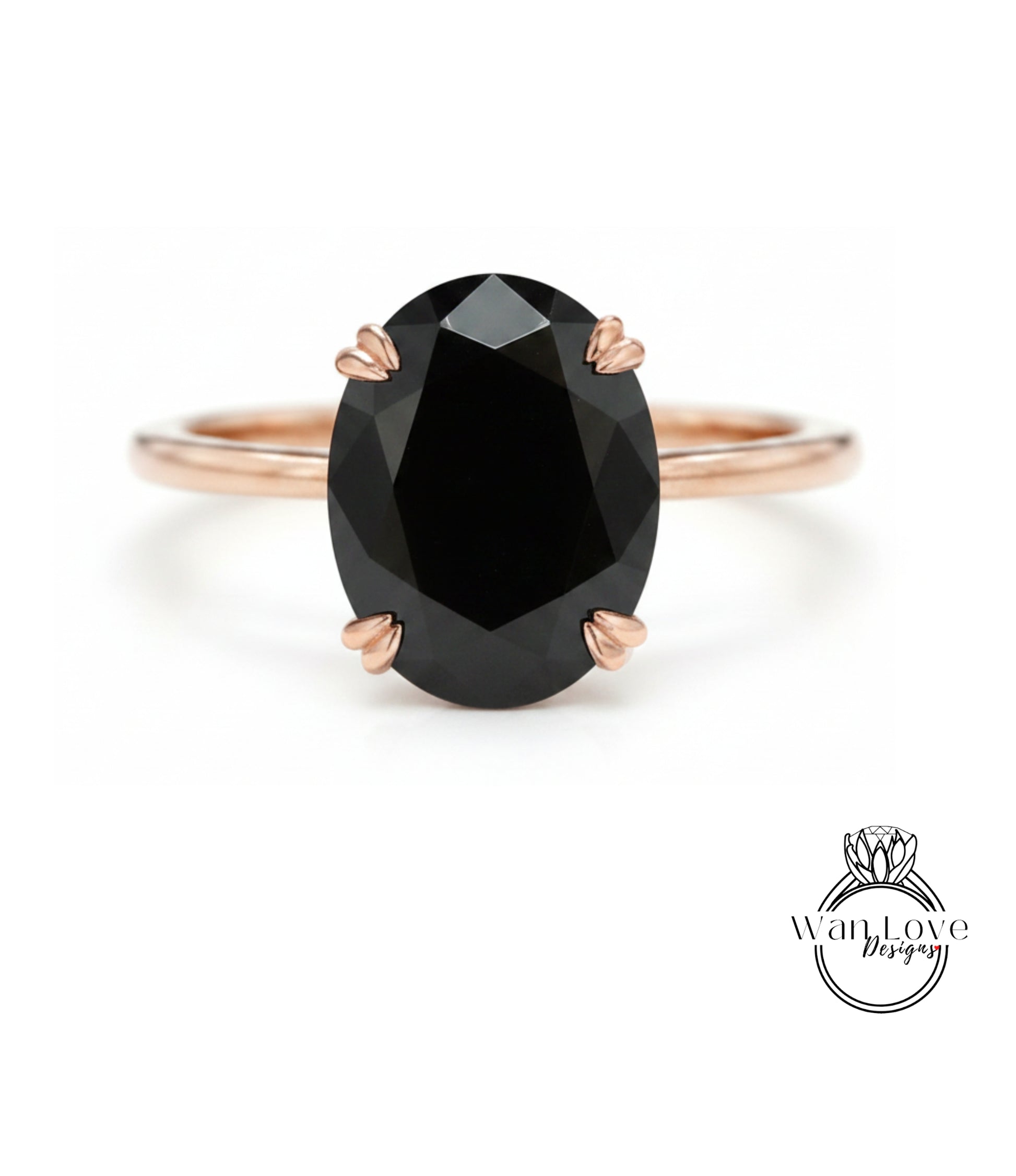 A rose gold ring with a large oval-shaped black gemstone set in the center.