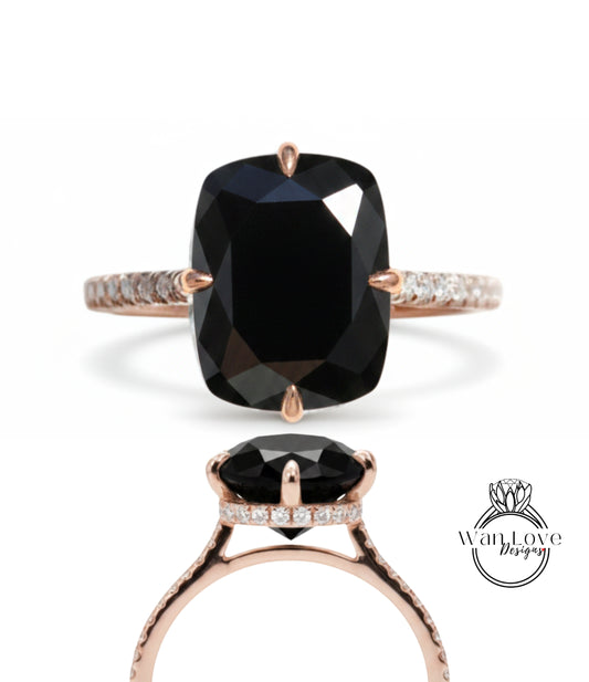 A large, black diamond ring with a rose gold band and a small diamond accent.