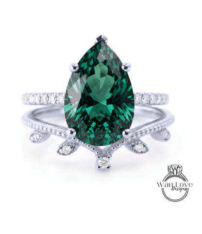A close-up of a silver ring with a large, dark green gemstone at the center, surrounded by smaller diamonds.