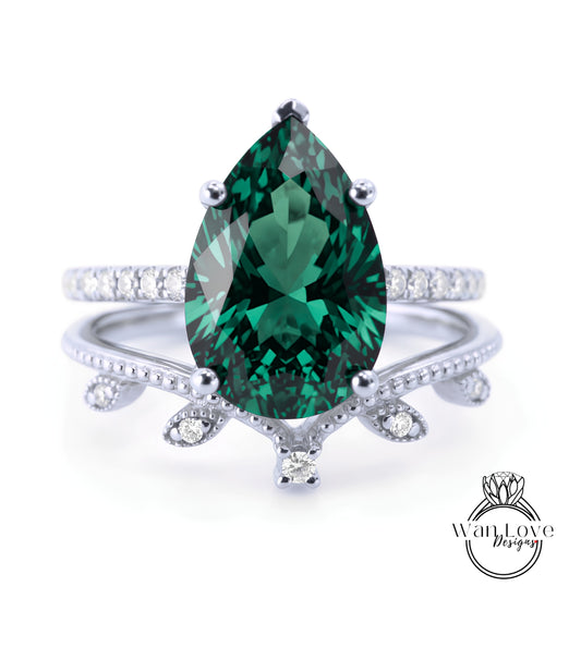 A close-up of a silver ring with a large, dark green gemstone at the center, surrounded by smaller diamonds.