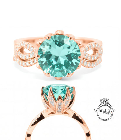 a beautiful ring with a large turquoise gemstone set in a rose gold band. The ring has a delicate floral design around the gemstone, adding elegance and sophistication to the piece.