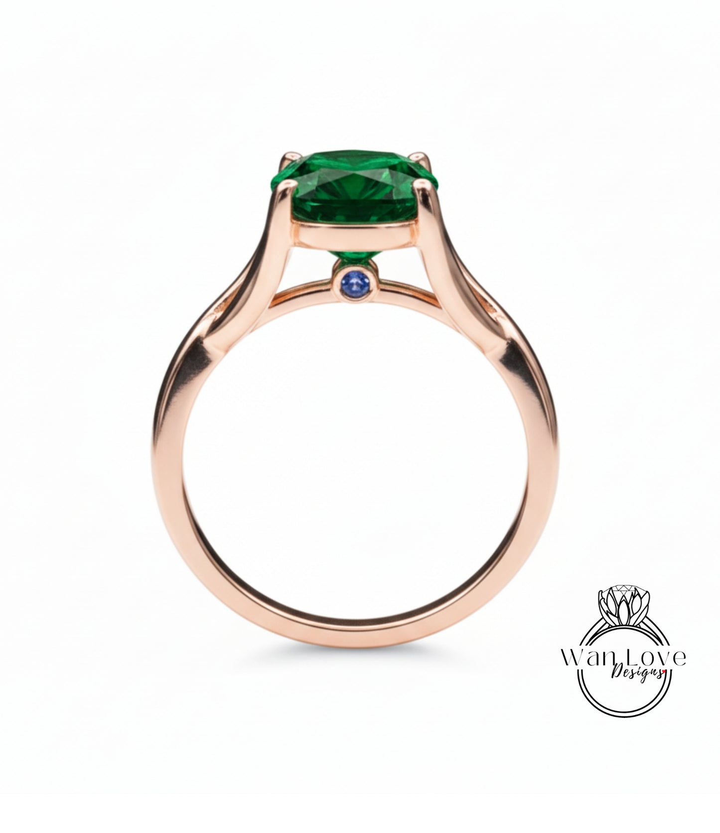 A rose gold ring with a large green gemstone, possibly a diamond, set in the center.