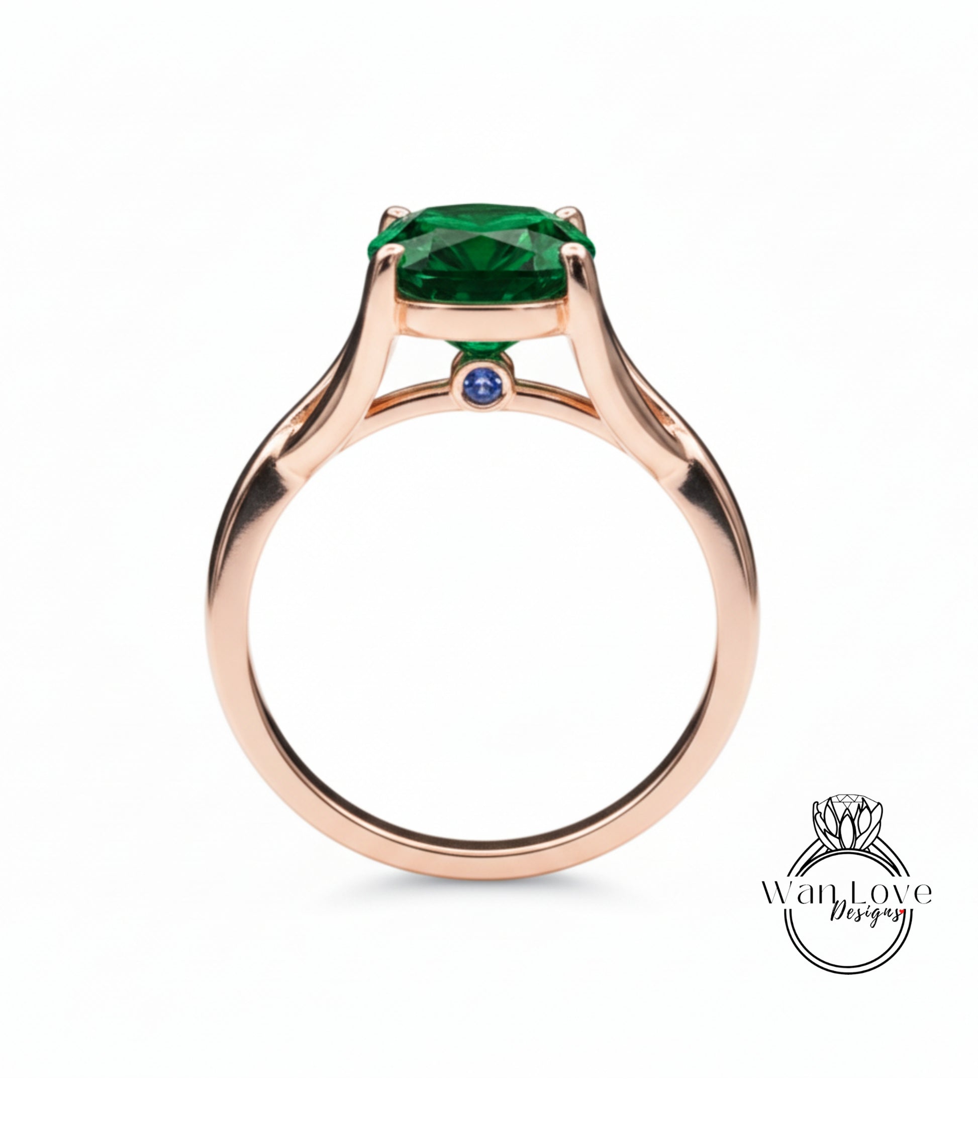A rose gold ring with a large green gemstone, possibly a diamond, set in the center.
