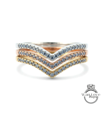 A ring with three layers of rings, each with a diamond set in a different color.