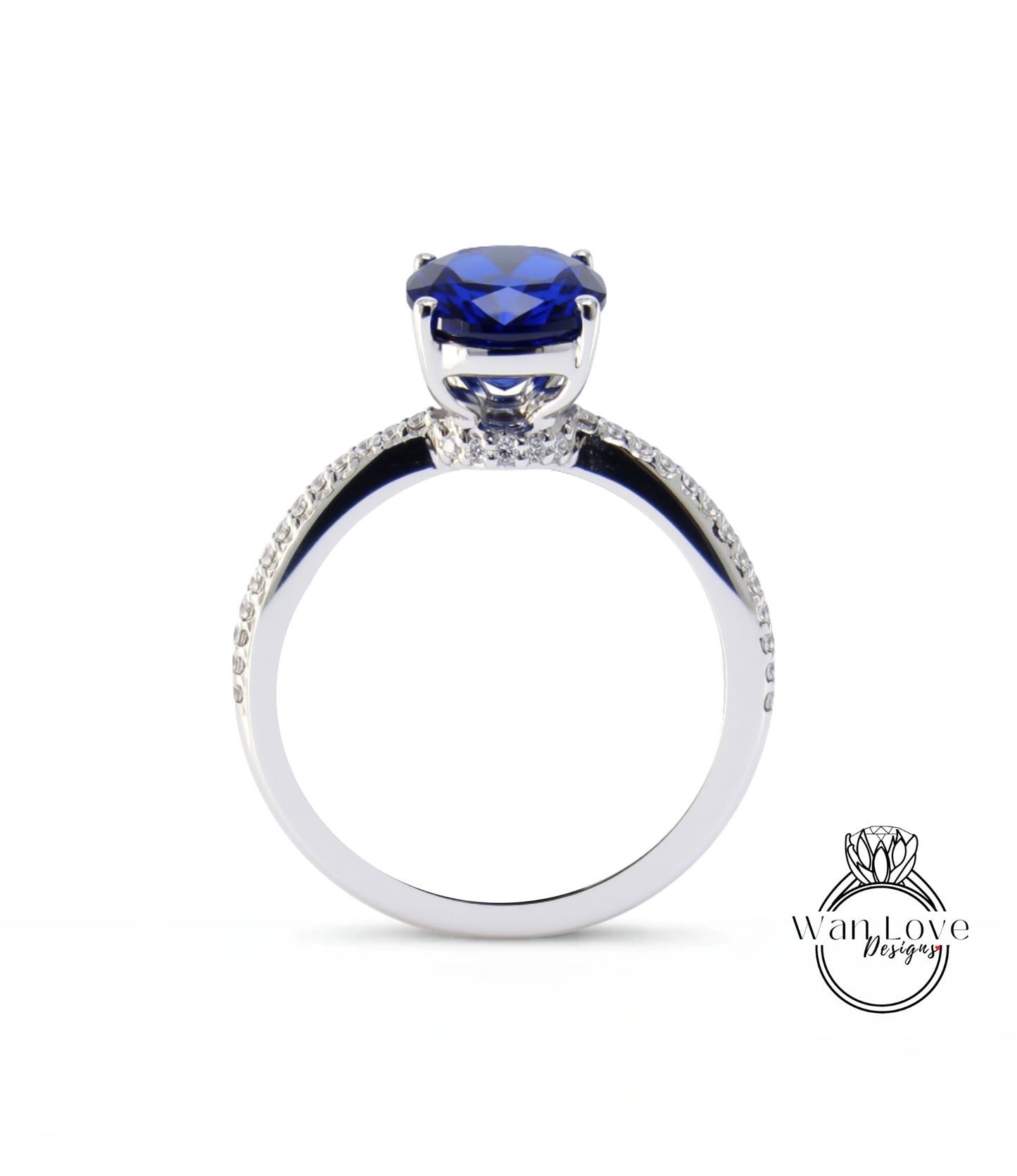 A silver ring with a large blue gemstone, likely a sapphire, at the center.