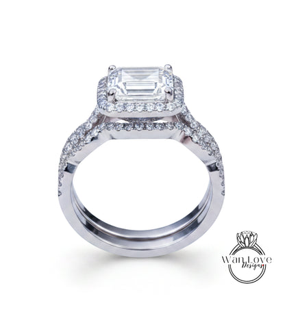 A stunning diamond engagement ring with a large central diamond surrounded by smaller diamonds on either side, set in a silver band.