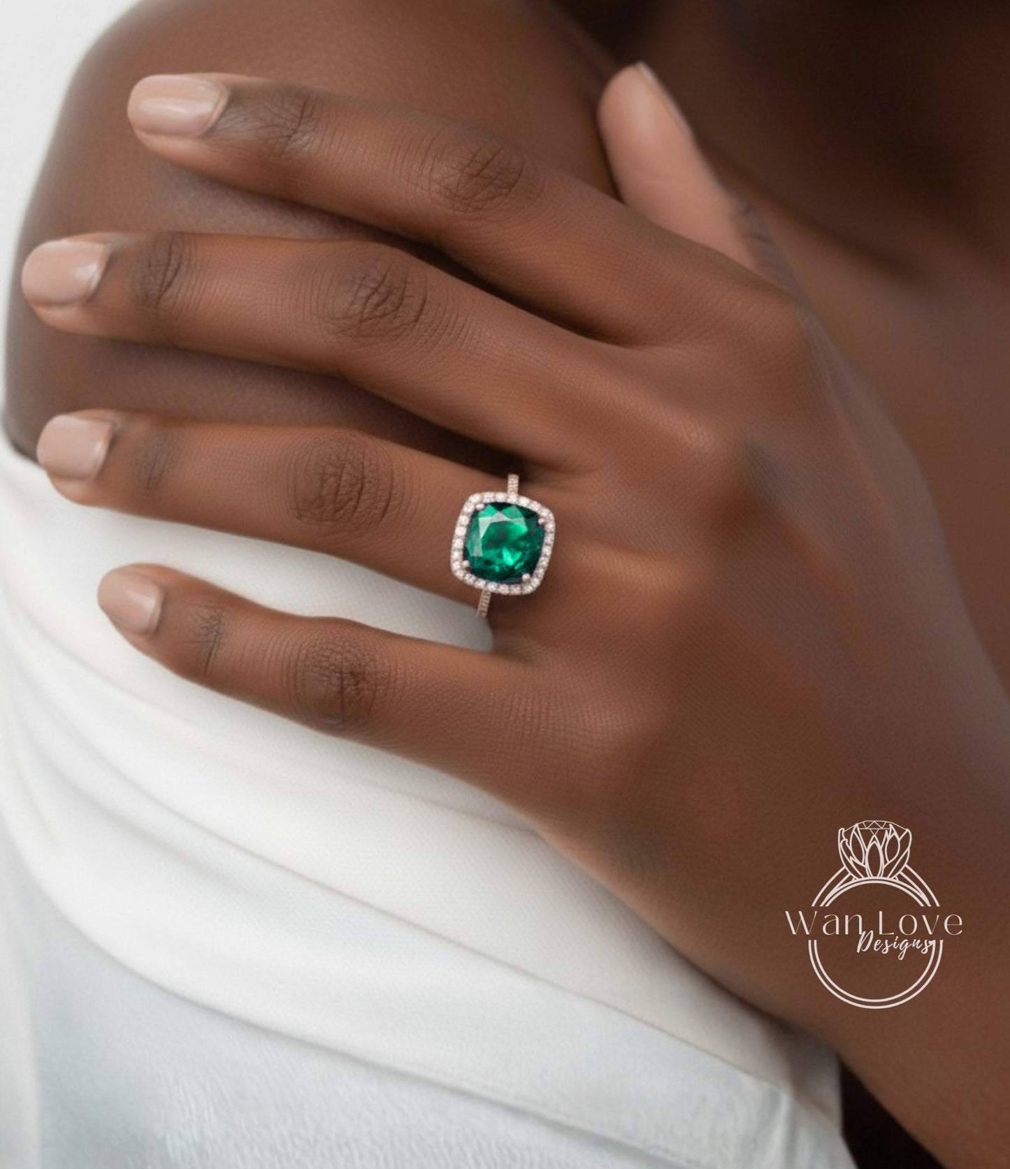 A close-up of a person's hand wearing a ring with a large, green gemstone.