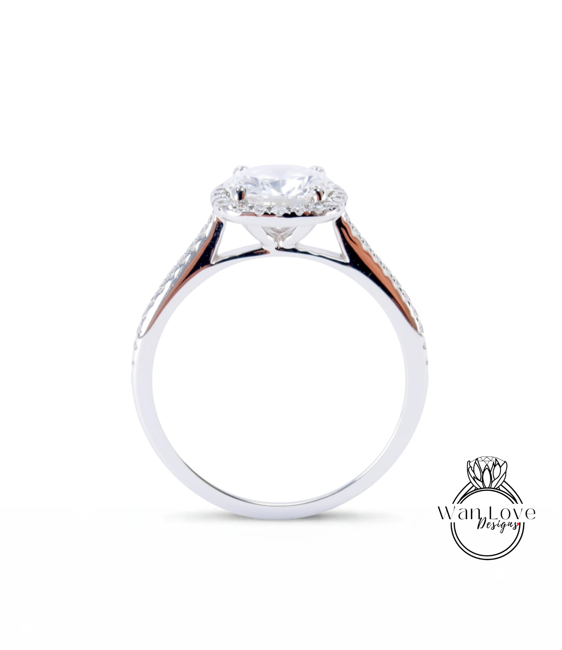A silver engagement ring with a large central diamond and a halo of smaller diamonds around the center stone.