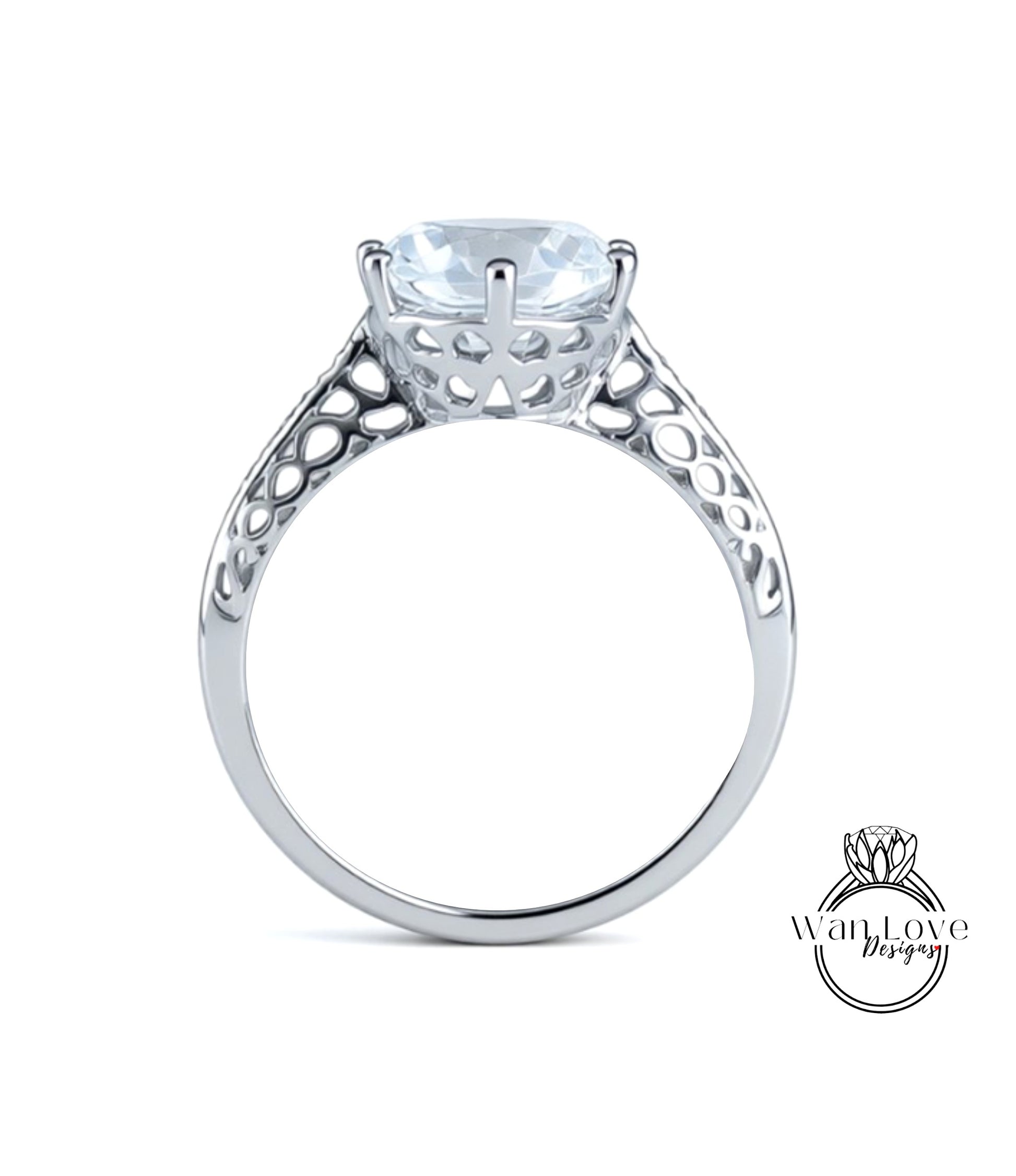 A silver engagement ring with a large, clear gemstone set in the center.