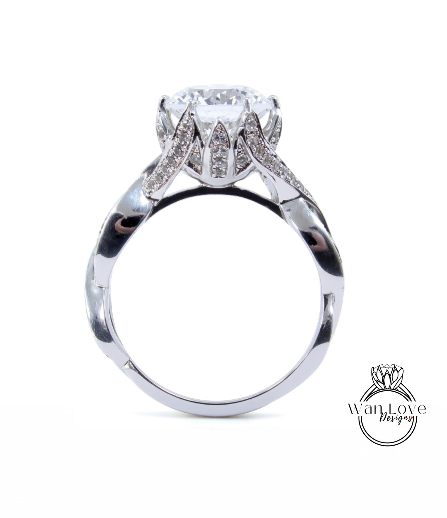 A silver ring with a large, round diamond at the center, surrounded by smaller diamonds.